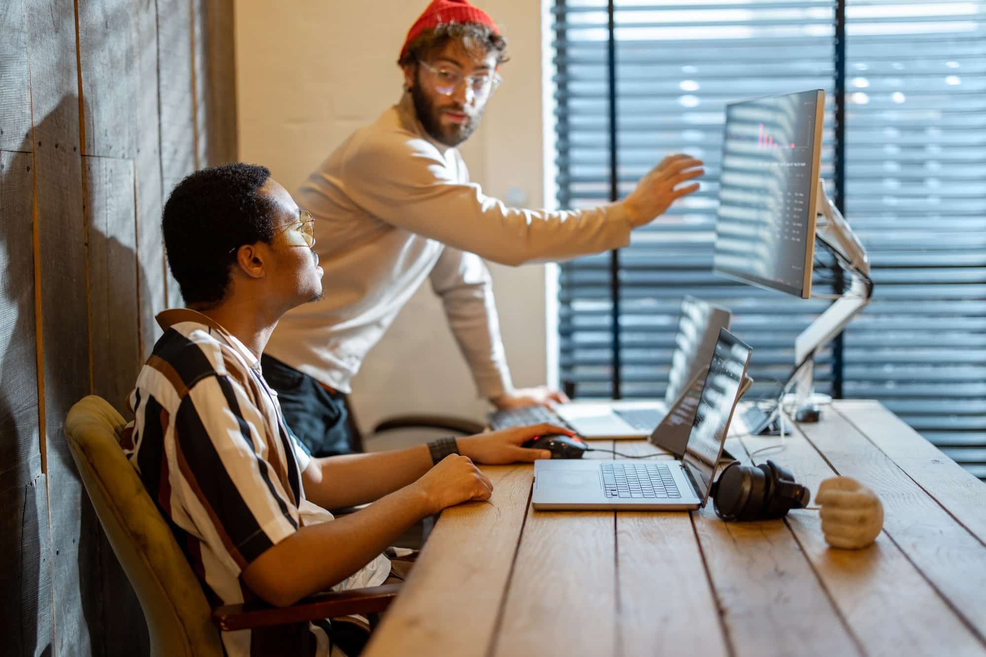 two-men-working-on-computer-at-home-office